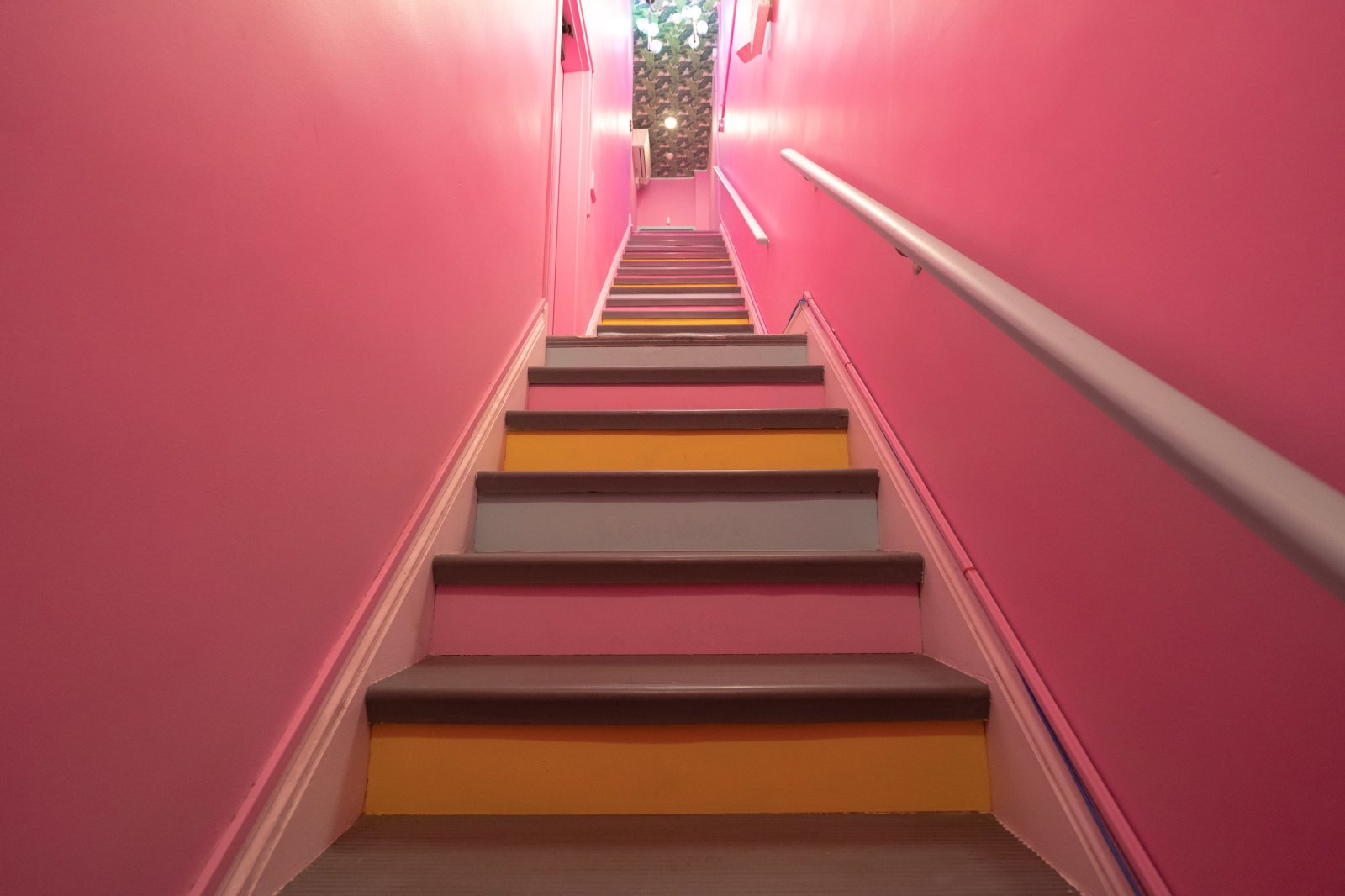 Pink staircase entrance leading up to 305 Fitness Philly